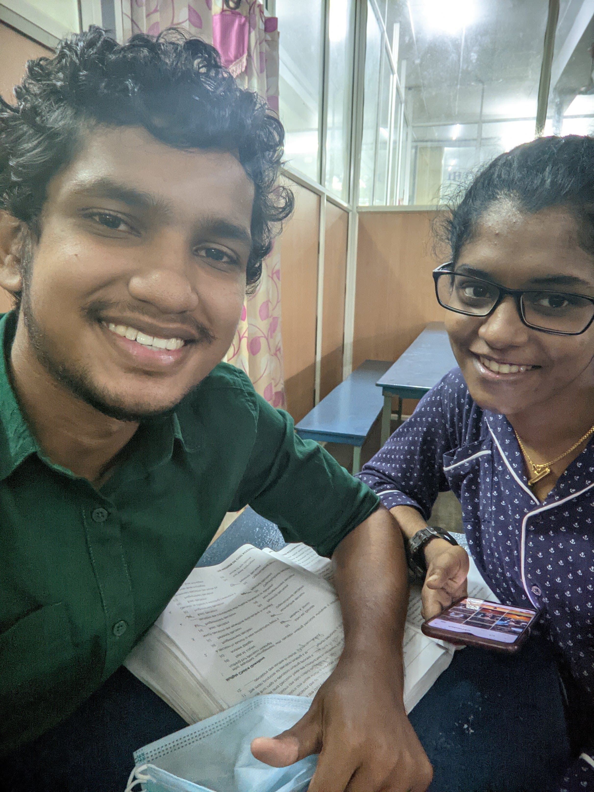 Smiling selfie at a study table